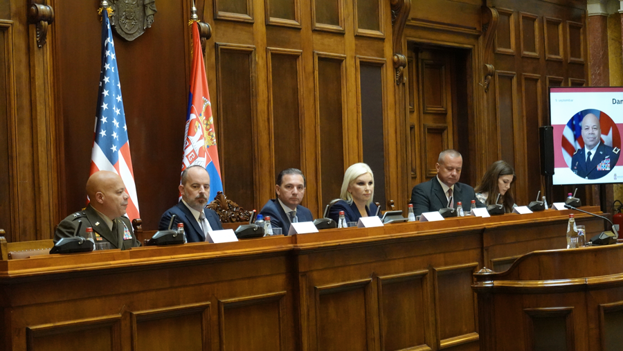 Maj. Gen. John C. Harris Jr. sits in row at head of court with Serbian officials.