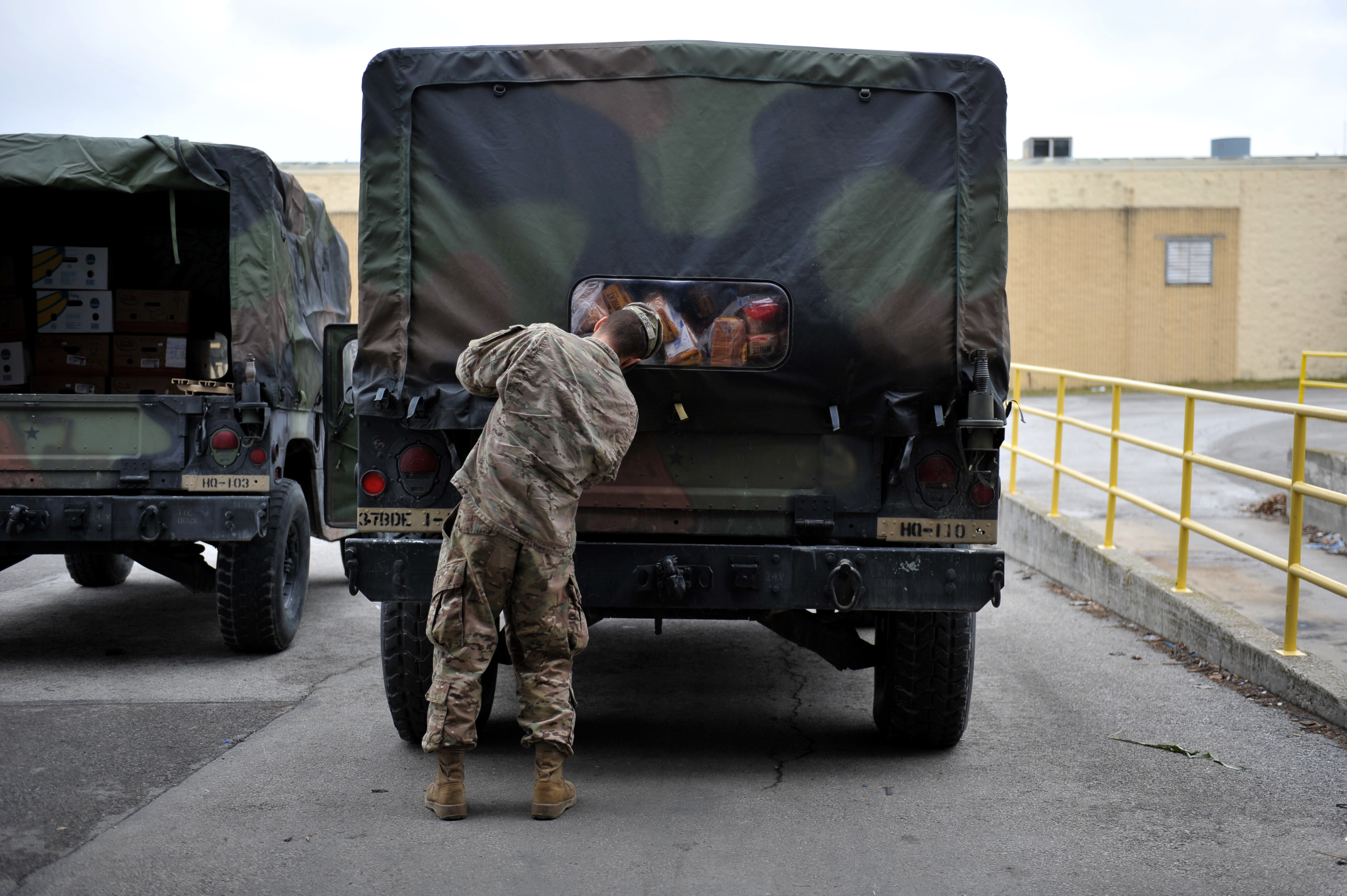 Soldier secures back of a truck.