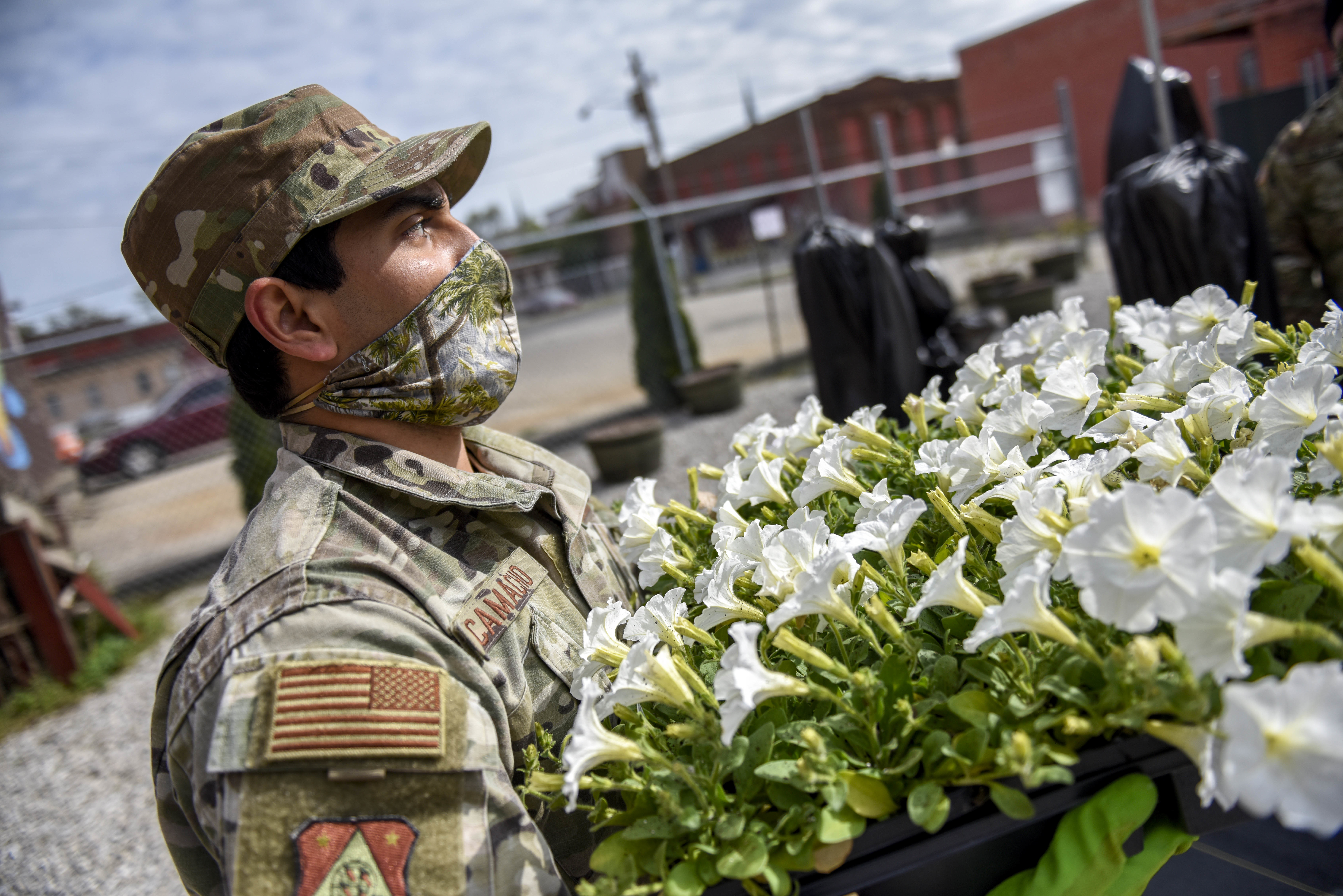 Soldier carries flowers