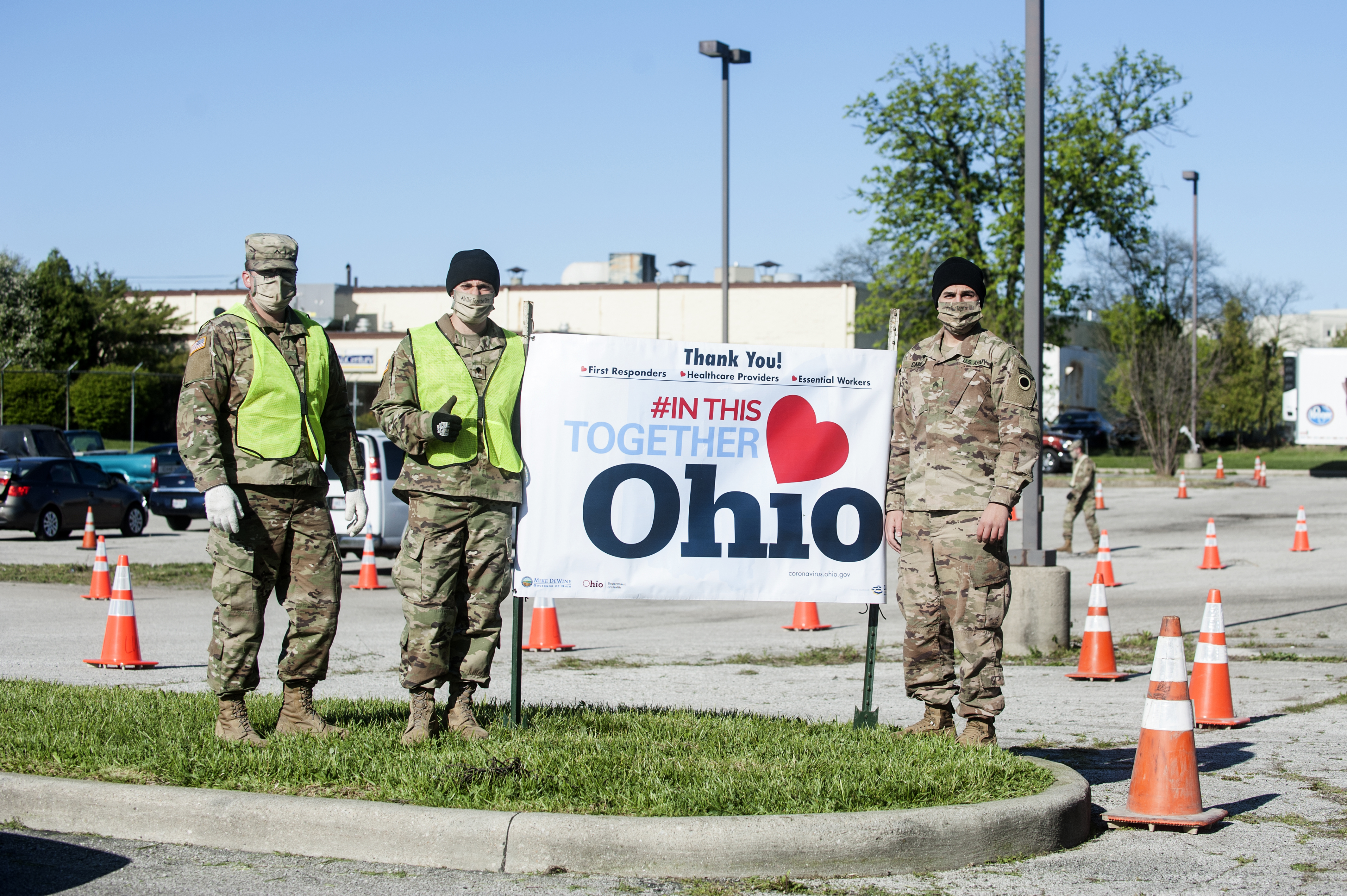 Soldiers around sign that reads #IN THIS TOGETHER OHIO