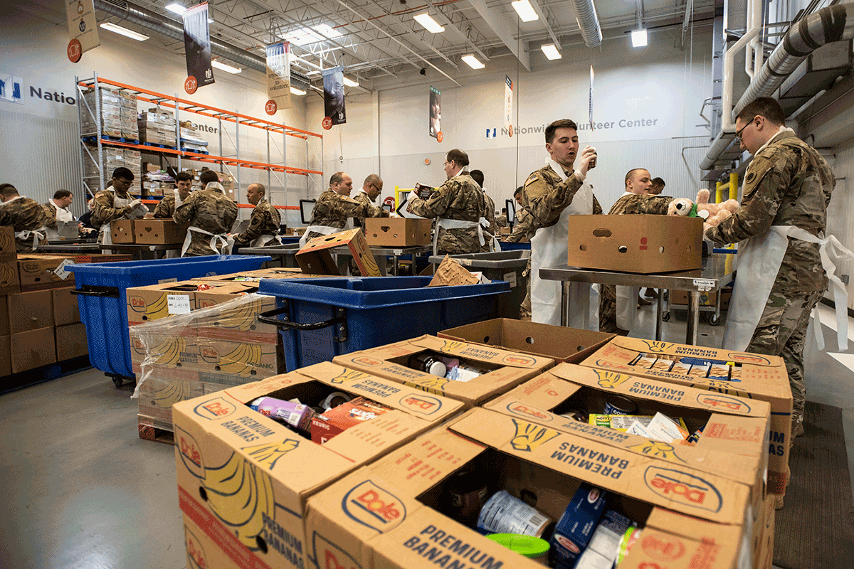 Soldiers pack boxes.