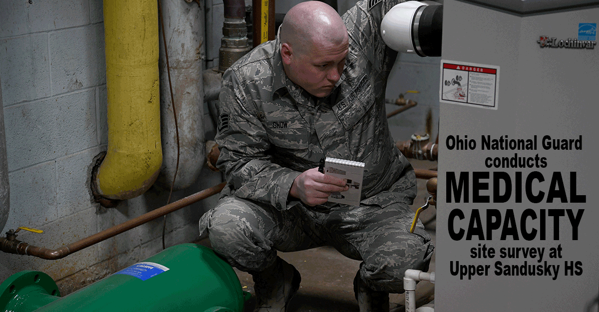 Airman inspects water heater.