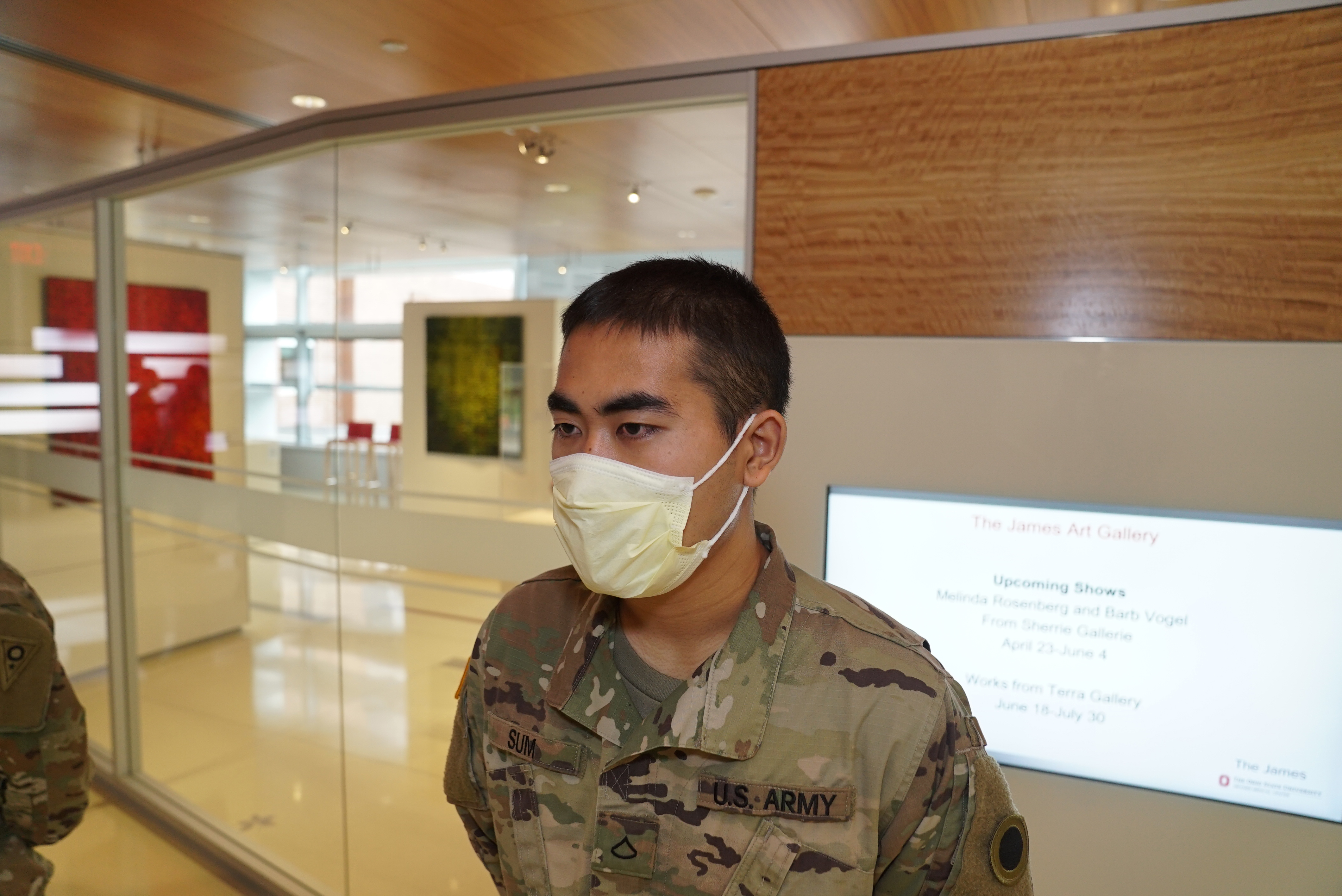 Head shot of Pfc. Dal Sum with mask in hospital lobby