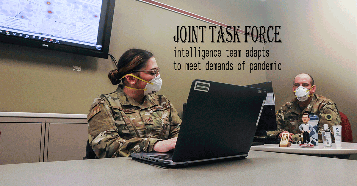 Soldiers wearing masks work at laptops in conference room,