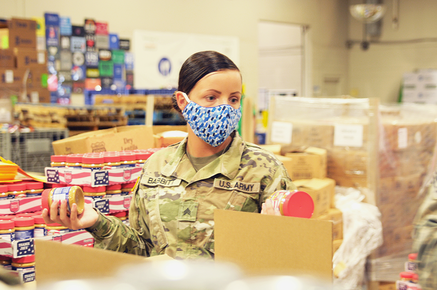 Female Soldier packs groceries.