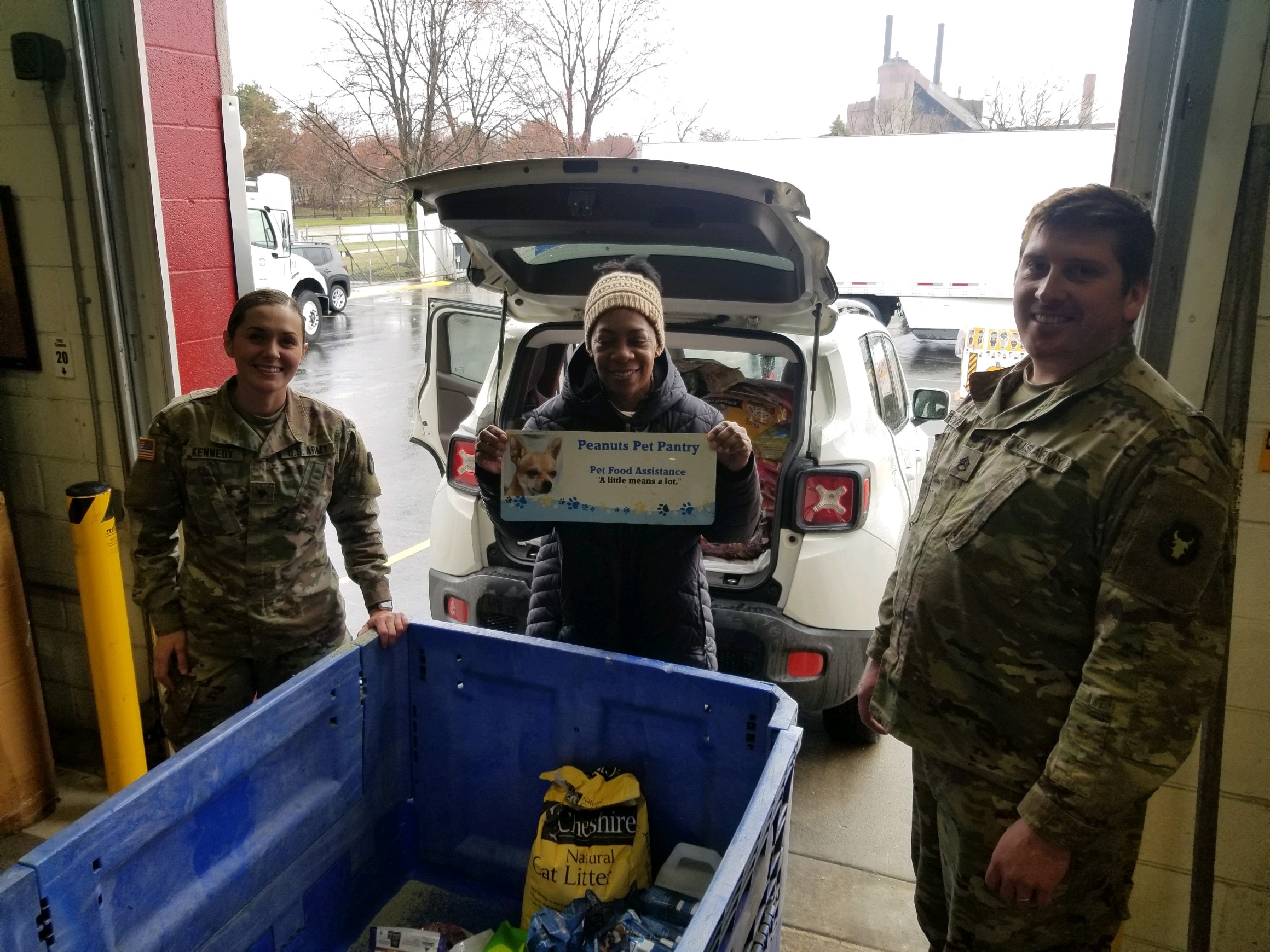 Soldiers load car with pet supplies.