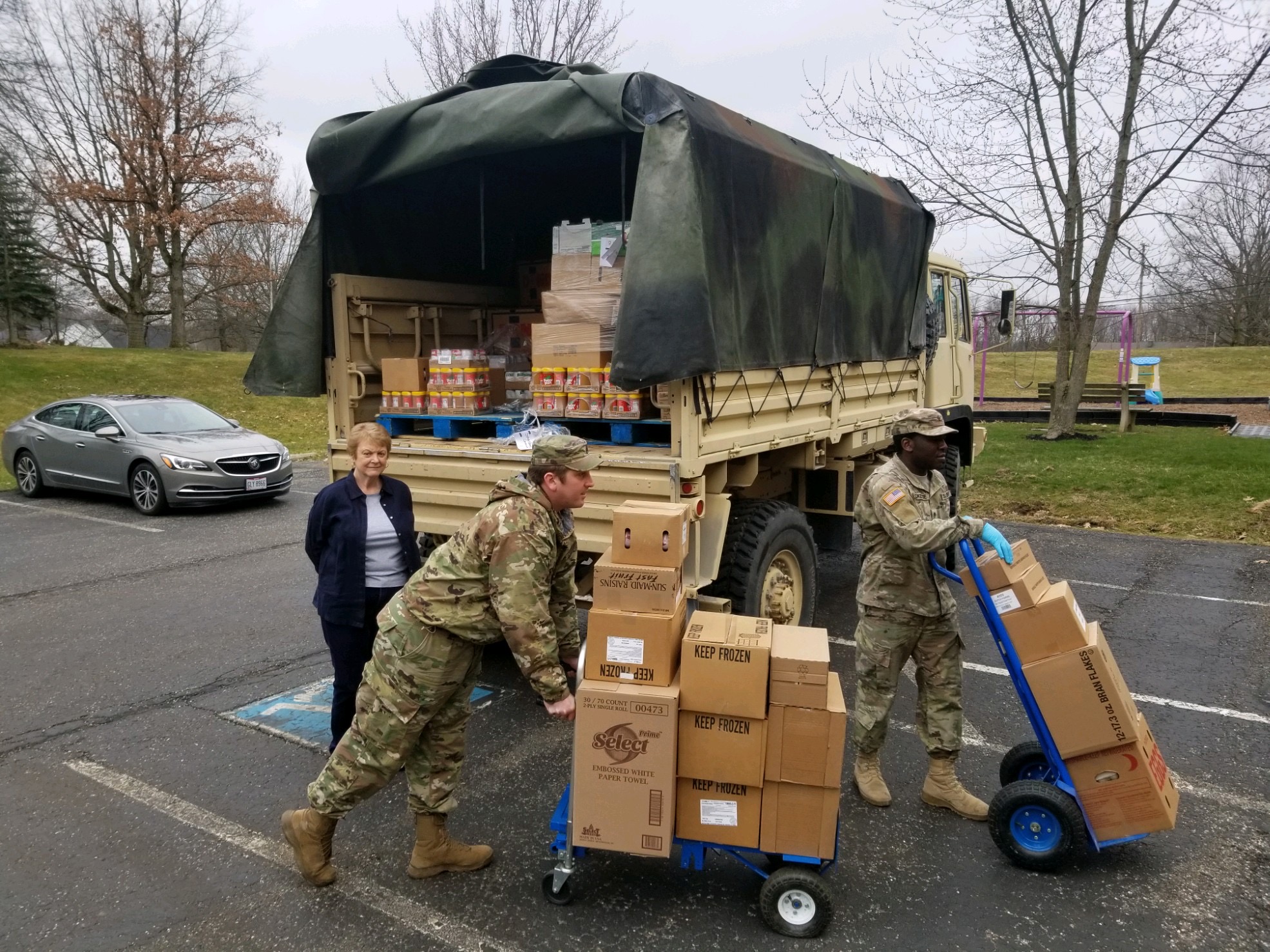Soldiers unload food truck.